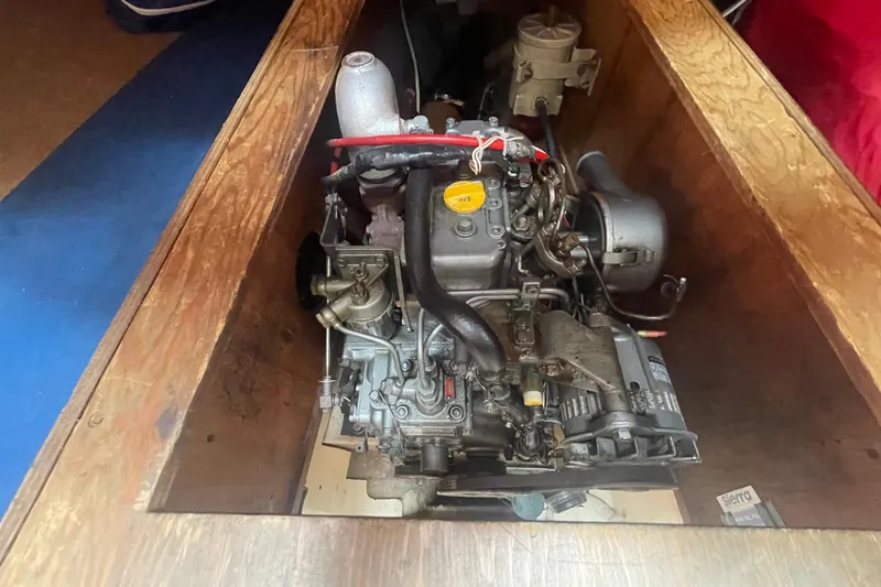 Slide: The Image of Engine compartment of a 1980 Falmouth Cutter sailboat, showcasing mechanical components. - 21