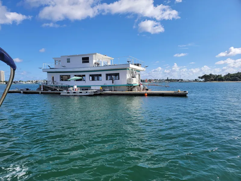 Slide: The Image of Floating home on water, Custom model, 2003, under a clear blue sky. - 12