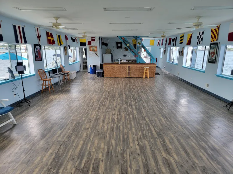 Slide: The Image of Spacious interior of a 2003 custom floating home with nautical decor and wooden flooring. - 16