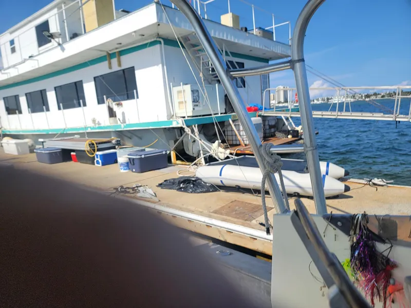 Slide: The Image of Floating home docked by the water, Custom model, 2003, with clear blue sky. - 22