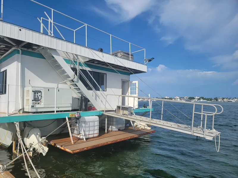 Slide: The Image of Custom 2003 floating home with deck and stairs on a sunny day. - 25