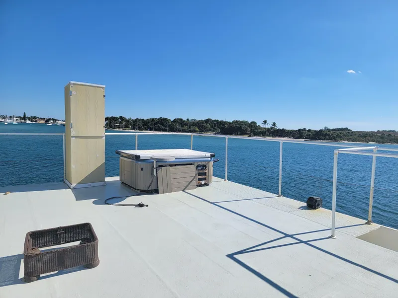 Slide: The Image of Rooftop deck of a 2003 custom floating home with hot tub, overlooking serene water views. - 31