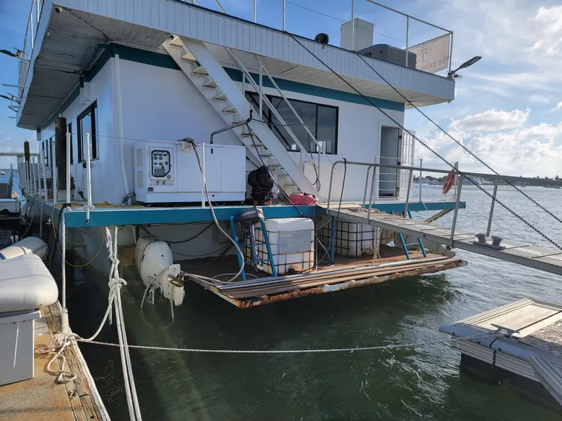 Slide: The Image of Custom 2003 floating home docked on water, featuring stairs and deck. - 43
