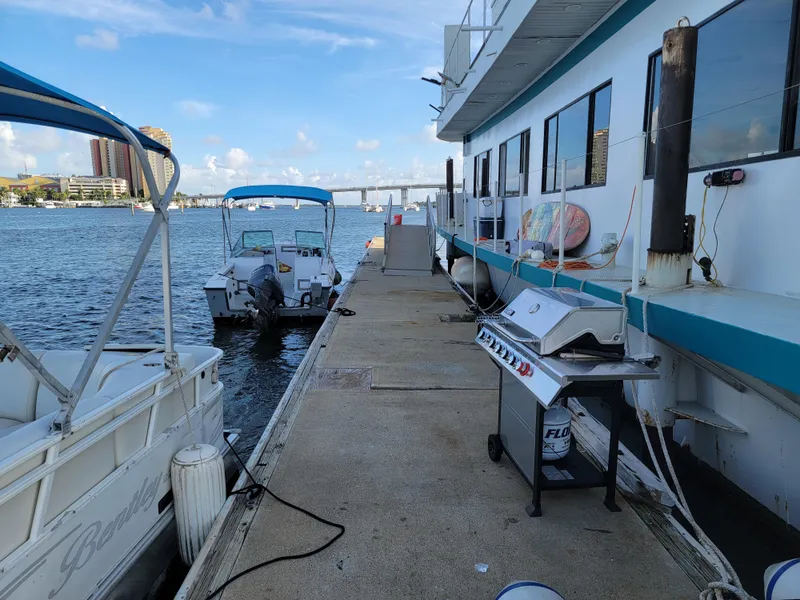 Slide: The Image of Docked floating home with boats and grill, Custom model, 2003, waterfront view. - 45
