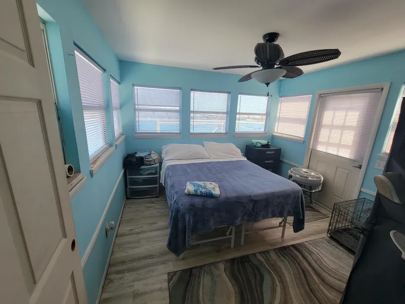 Slide: The Image of Cozy bedroom in a 2003 custom floating home with blue walls and waterfront views. - 48