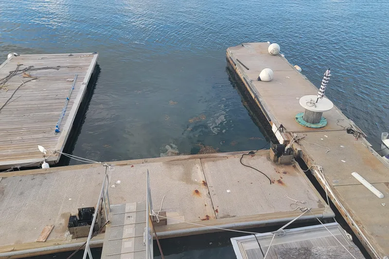 Slide: The Image of Floating marina docks with ropes and buoys on calm water, Custom model, 2003. - 71