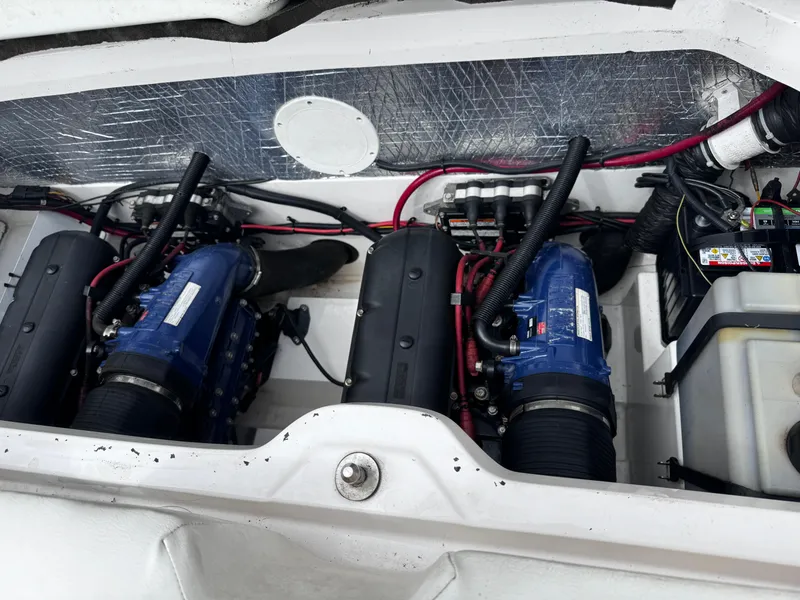 Slide: The Image of Engine compartment of a 2003 Yamaha Boats 210LX, featuring dual engines and wiring. - 19