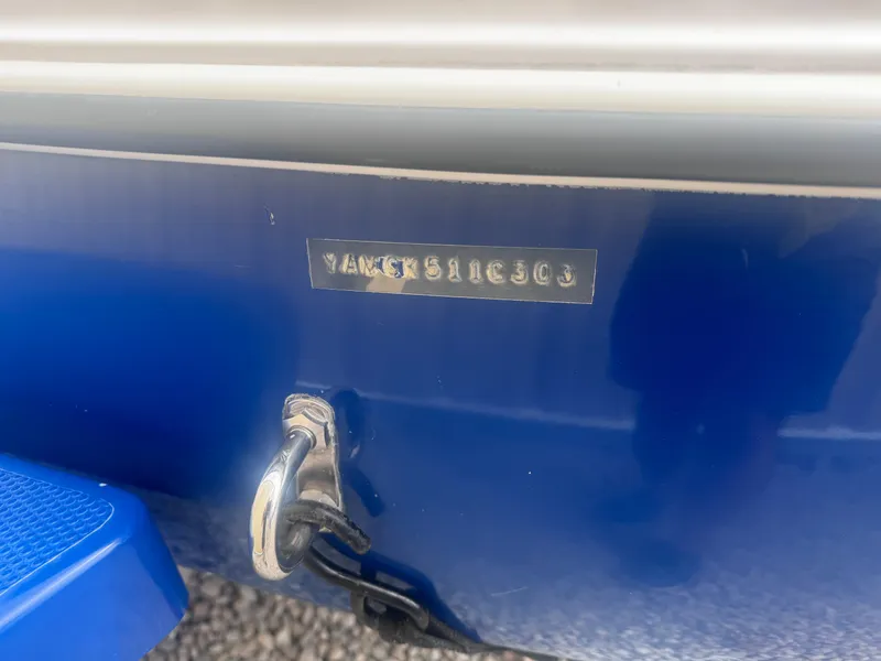 Slide: The Image of 2003 Yamaha Boats 210LX hull identification number on blue surface. - 16
