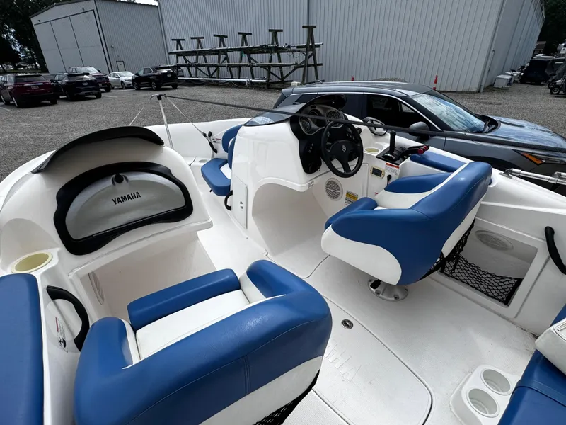 Slide: The Image of 2003 Yamaha Boats 210LX interior with blue and white seating, steering wheel, and dashboard. - 5