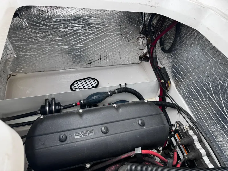 Slide: The Image of Engine compartment of a 2003 Yamaha Boats 210LX with visible wiring and components. - 13