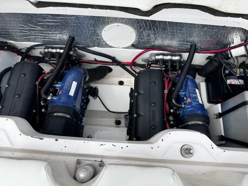 Slide: The Image of Engine compartment of a 2003 Yamaha Boats 210LX, showcasing dual engines and wiring. - 14
