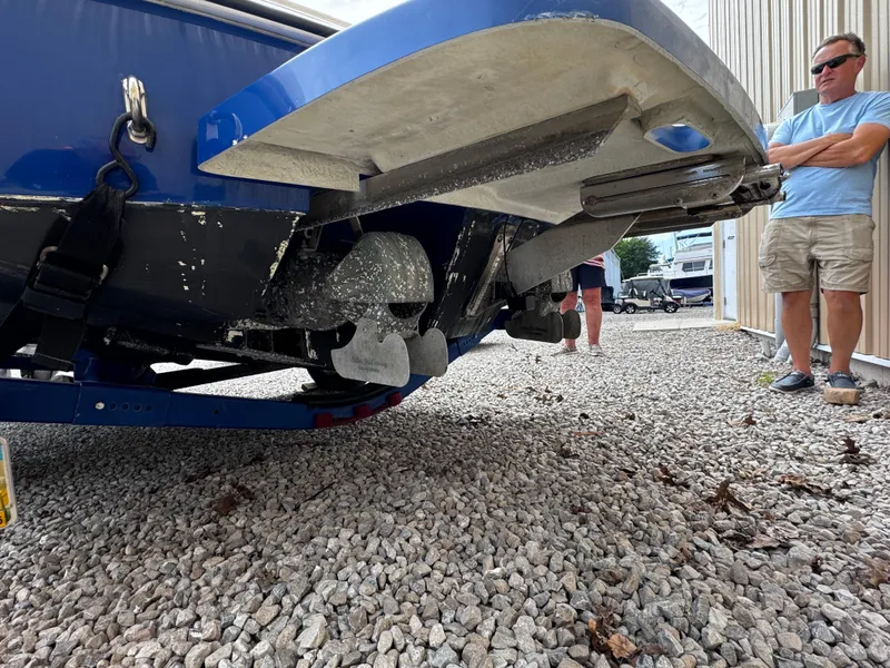 Slide: The Image of 2003 Yamaha Boats 210LX on trailer, viewed from rear, with people standing nearby. - 3