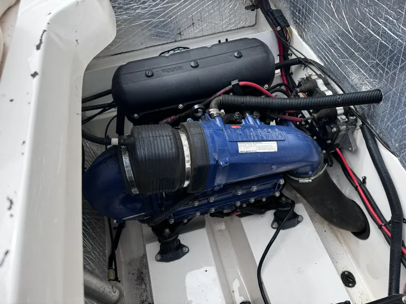 Slide: The Image of Engine compartment of a 2003 Yamaha Boats 210LX, featuring a blue engine component. - 20