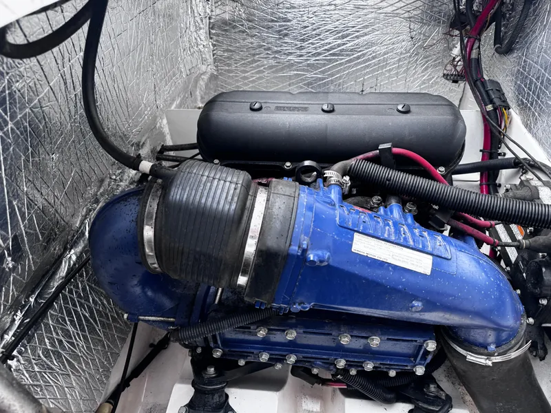 Slide: The Image of Engine compartment of a 2003 Yamaha Boats 210LX, featuring a blue Yamaha engine. - 12