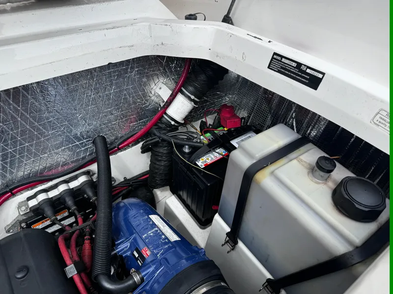Slide: The Image of Engine compartment of a 2003 Yamaha Boats 210LX, showing battery and components. - 18