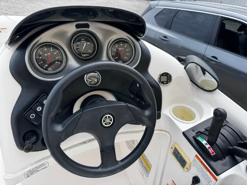 Slide: The Image of Dashboard of a 2003 Yamaha Boats 210LX, featuring steering wheel and control panel. - 6