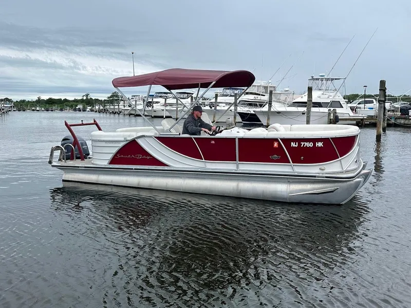 The Image of 2017 South Bay 500RS pontoon boat with red canopy on calm water. - 0