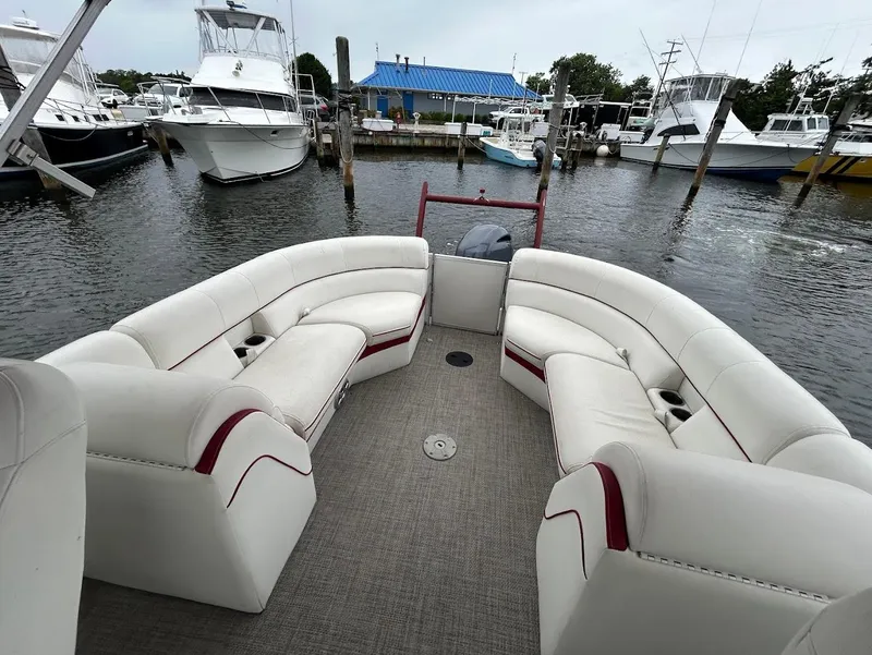 Slide: The Image of 2017 South Bay 500RS pontoon boat with white seating, docked in a marina. - 12