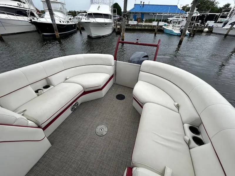 Slide: The Image of 2017 South Bay 500RS boat interior with white seating at a marina. - 13