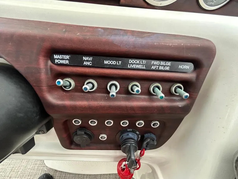 Slide: The Image of Control panel of a 2017 South Bay 500RS boat with labeled switches and key ignition. - 16