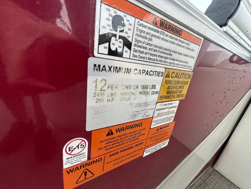 Slide: The Image of Warning labels on a 2017 South Bay 500RS boat, detailing capacity and safety information. - 18