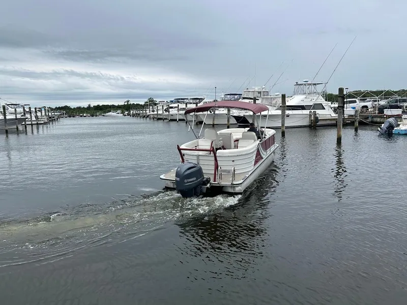 Slide: The Image of 2017 South Bay 500RS pontoon boat navigating marina waters. - 7