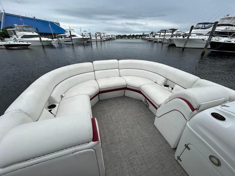 Slide: The Image of 2017 South Bay 500RS pontoon boat with spacious seating, docked in a marina. - 8