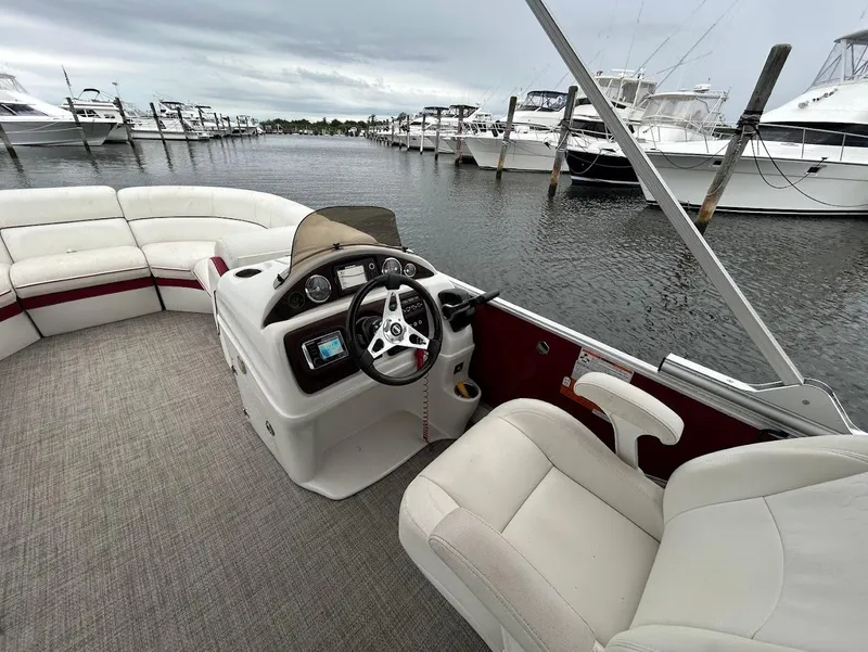 Slide: The Image of Pontoon boat interior, South Bay 500RS 2017, docked at marina with overcast sky. - 9