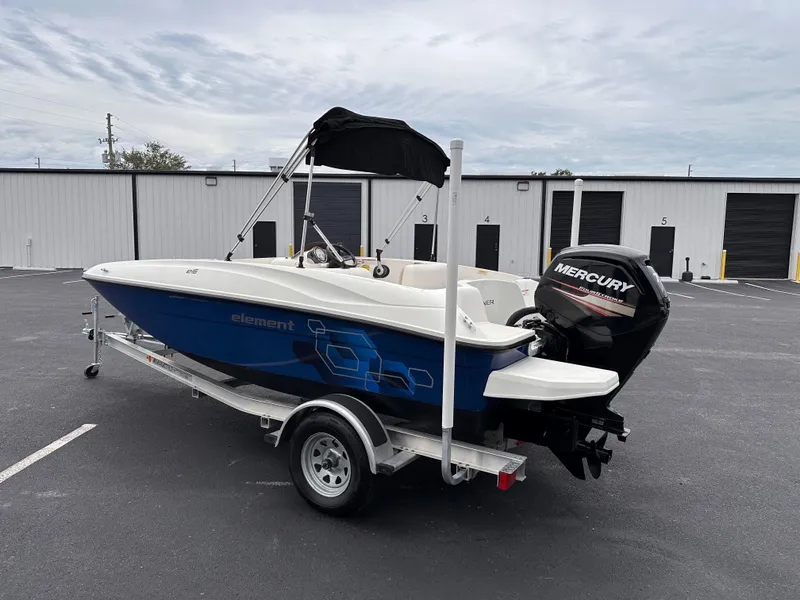 Slide: The Image of 2020 Bayliner Element boat with Mercury outboard motor on trailer. - 1