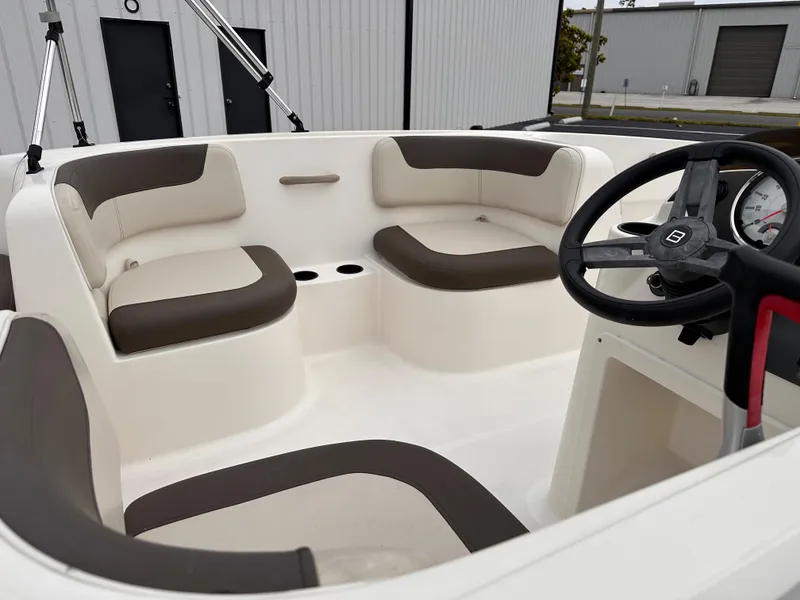 Slide: The Image of 2020 Bayliner Element boat interior with cushioned seating and steering wheel. - 5