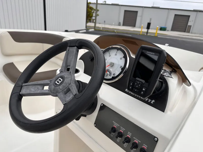 Slide: The Image of 2020 Bayliner Element boat dashboard with steering wheel, gauges, and Garmin GPS. - 6