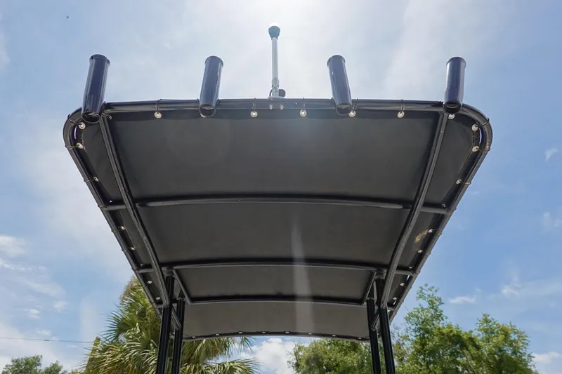 Slide: The Image of T-top of 2022 Key Largo 1800 Center Console boat under sunny sky. - 12