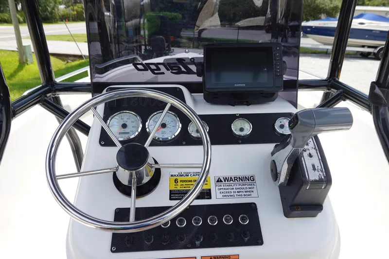 Slide: The Image of 2022 Key Largo 1800 Center Console dashboard with steering wheel and navigation controls. - 14