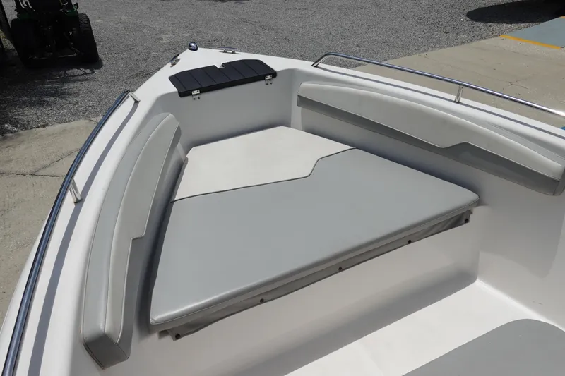 Slide: The Image of 2022 Key Largo 1800 Center Console boat interior with cushioned seating and storage. - 21