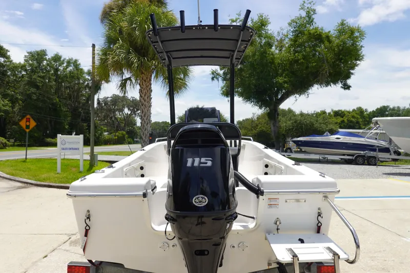 Slide: The Image of 2022 Key Largo 1800 Center Console boat with 115 HP engine, parked outdoors. - 5