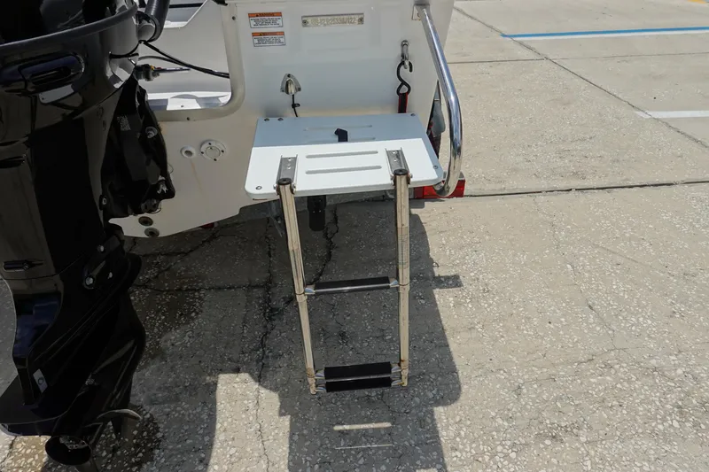 Slide: The Image of Key Largo 1800 Center Console 2022 boat with foldable swim ladder and outboard motor. - 6