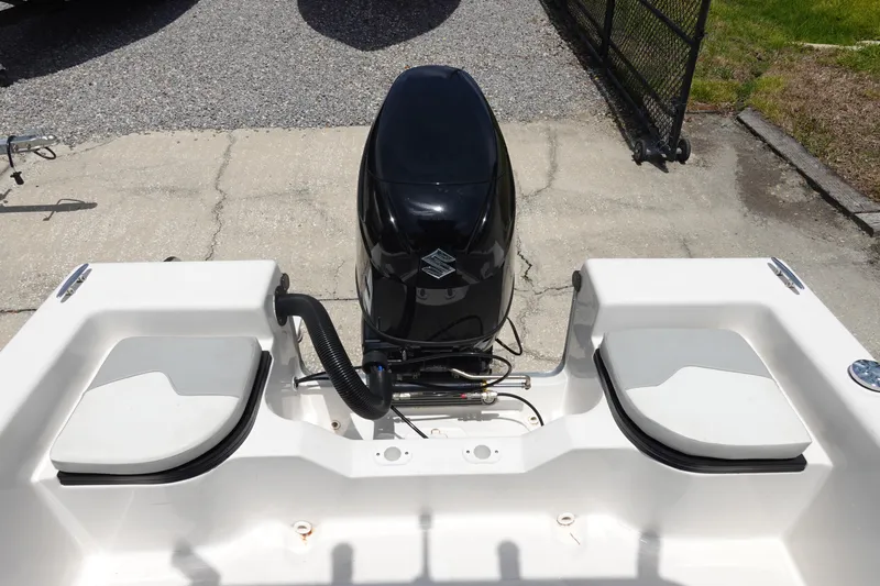 Slide: The Image of 2022 Key Largo 1800 Center Console boat with outboard motor, parked on concrete. - 8