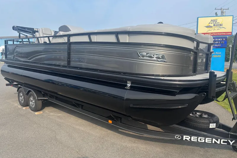 Slide: The Image of 2025 Regency 250 DL3 pontoon boat on trailer at Port Harbor Marine. - 1