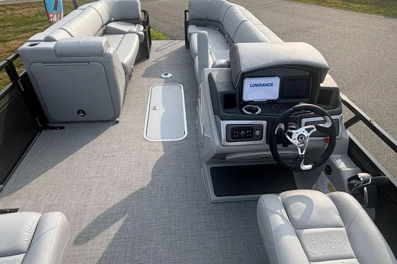 Slide: The Image of 2025 Regency 250 DL3 pontoon boat interior with modern helm and seating. - 11