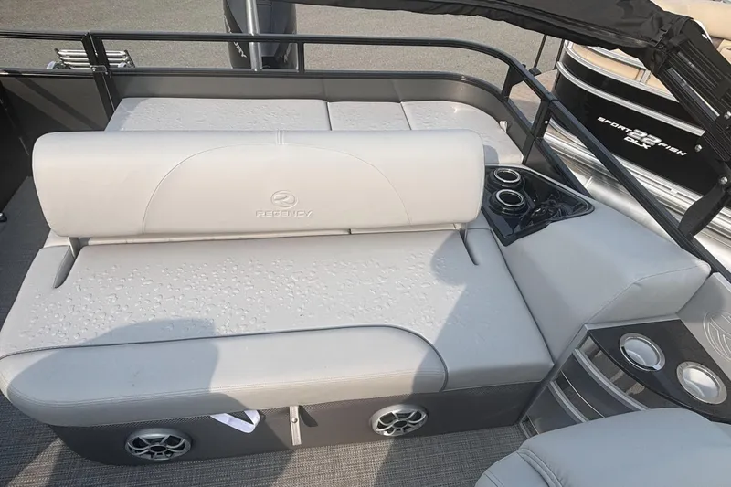 Slide: The Image of 2025 Regency 250 DL3 boat interior with cushioned seating and cup holders. - 12
