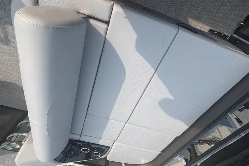 Slide: The Image of 2025 Regency 250 DL3 boat seat with cup holders and water droplets. - 13
