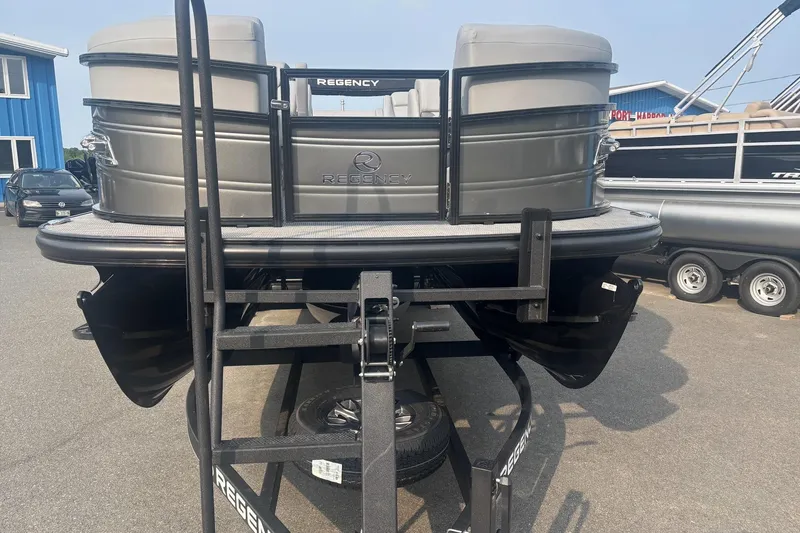 Slide: The Image of 2025 Regency 250 DL3 pontoon boat on trailer, displayed outdoors. - 2