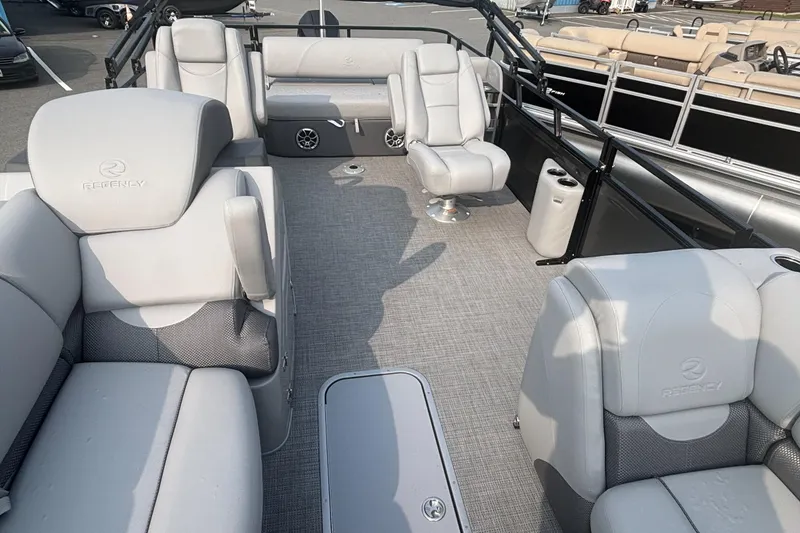 Slide: The Image of Luxurious 2025 Regency 250 DL3 pontoon boat interior with plush seating and modern design. - 6