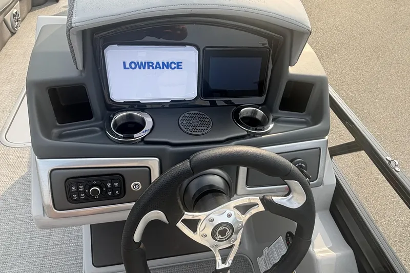 Slide: The Image of 2025 Regency 250 DL3 boat dashboard with Lowrance display and steering wheel. - 8