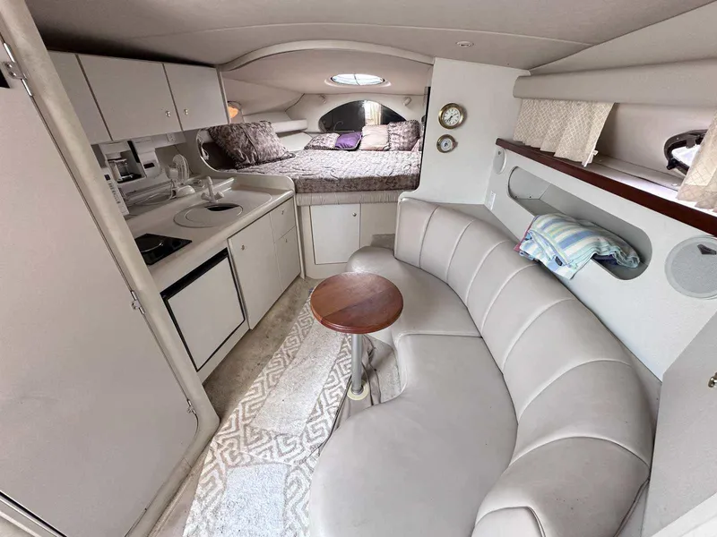 Slide: The Image of 1998 Cruisers Yachts 3075 Rogue interior with kitchenette, seating, and sleeping area. - 11