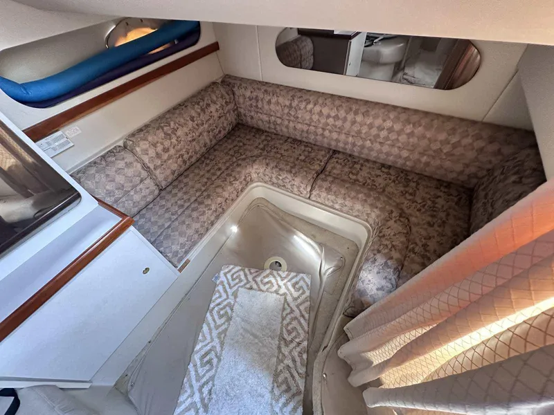 Slide: The Image of Interior of 1998 Cruisers Yachts 3075 Rogue with patterned seating and a small table. - 12
