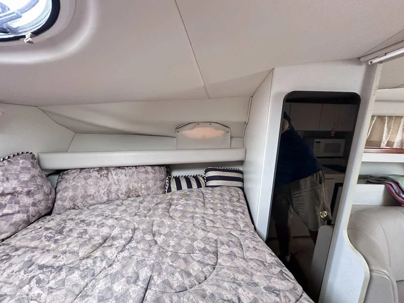 Slide: The Image of 1998 Cruisers Yachts 3075 Rogue cabin interior with bed and kitchenette. - 16