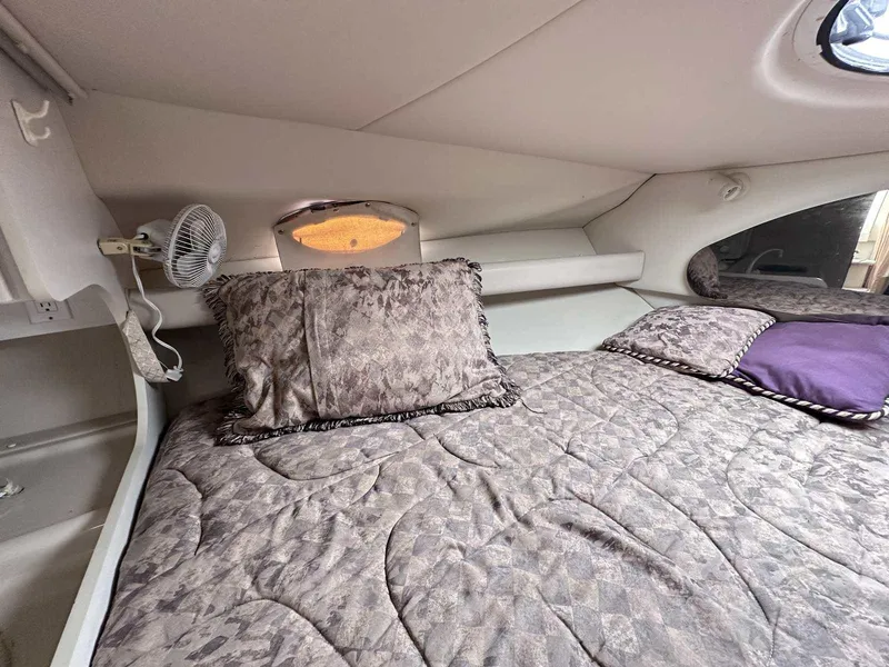 Slide: The Image of Interior cabin of 1998 Cruisers Yachts 3075 Rogue with cozy bedding and pillows. - 18