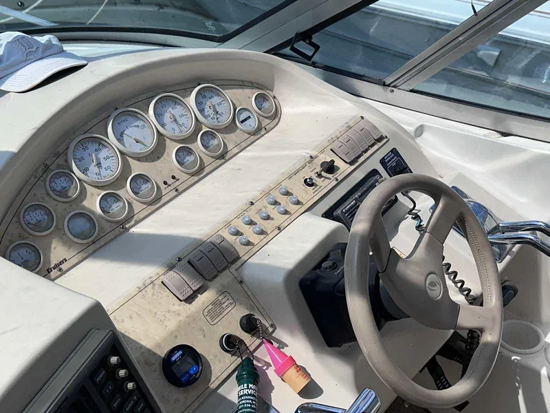 Slide: The Image of 1998 Cruisers Yachts 3075 Rogue dashboard with gauges and steering wheel. - 7