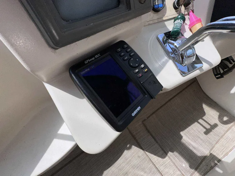Slide: The Image of 1998 Cruisers Yachts 3075 Rogue dashboard with Garmin GPSmap 182C and throttle controls. - 8